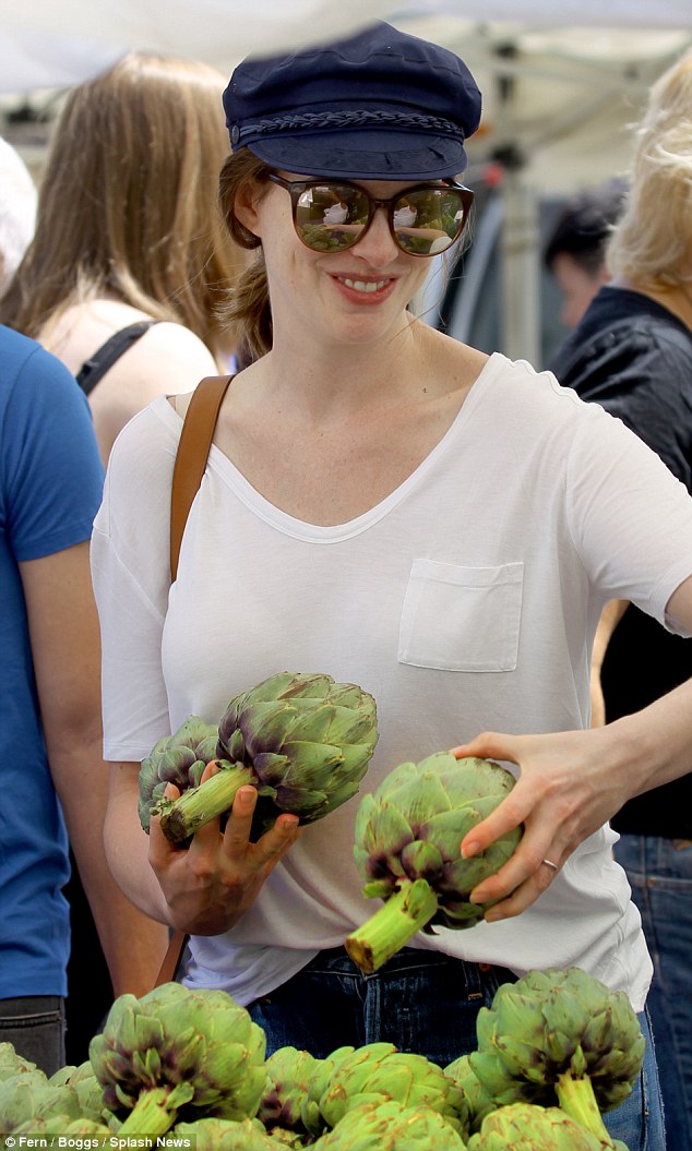 In good spirits: The Princess Diaries star - rocking Sunday Somewhere sunglasses - looked to be enjoying herself as she checked out a table of artichokes during the farmers' market visit