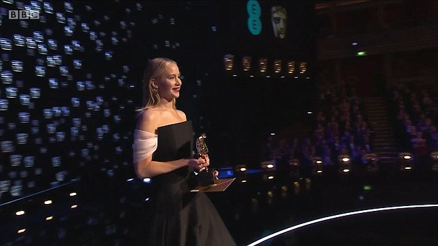 Her moment: Jennifer had a big smile on her face as she walked onto the stage with the gong in hand 