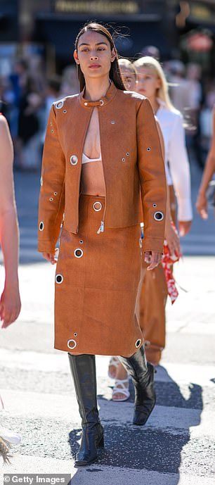 A guest at Copenhagen Fashion week paired a white stink bikini with a tan jacket and matching skirt