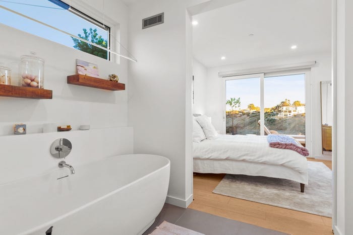 prefab home bathroom, white cabinets and sink looking into the batrhoom, dvele malibu