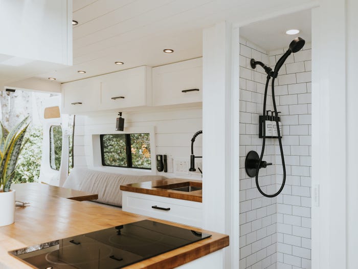 The shower and kitchen setup in the Lounge van.