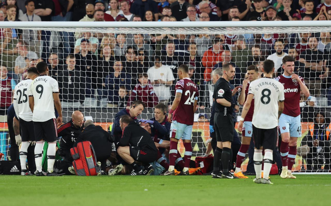 Wan-Bissaka and Soucek surrounded by doctors after horror head clash as fans can't believe they were allowed to play on | The Scottish Sun